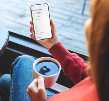 Lady on a mobile phone with a cup of coffee
